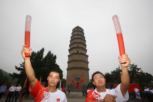 Photo: Torchbearers hold the torch high
