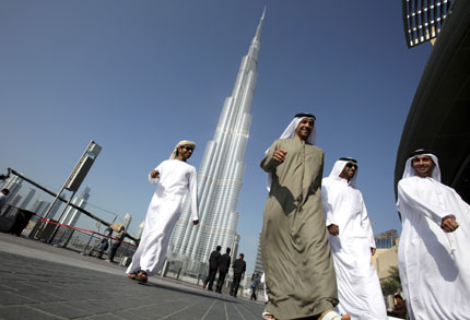 A group of Emiratis walk past the Burj Dubai Tower, the tallest tower in the world, on the day of its inauguration. Started at the height of the economic boom and built by some 12,000 labourers, the world's tallest building opened yesterday in Dubai as the glitzy emirate seeks to rekindle optimism after its financial crisis.  Read more: http://www.shanghaidaily.com/sp/article/2010/201001/20100105/article_424759.htm#ixzz0bhQLZ2Nb