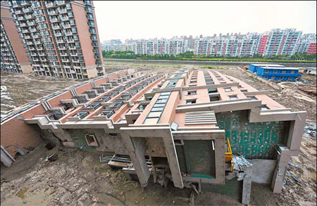 The collapsed building of the Lotus Riverside residential complex in Minhang district, Shanghai. The building fell to its side nearly intact on June 27, 2009, leaving one migrant worker dead. 