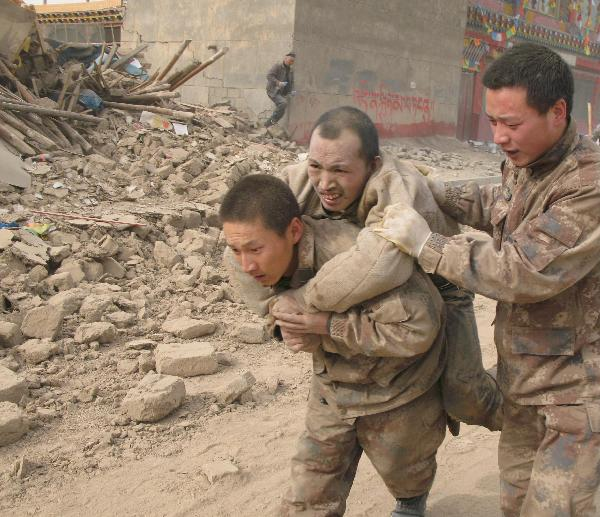 Soldiers of the Chinese People's Liberation Army rescue a survivor of quake in Yushu County, northwest China's Qinghai Province, April 14, 2010. About 400 people have died and 10,000 others were injured after a 7.1-magnitude earthquake hit Yushu early on Wednesday.