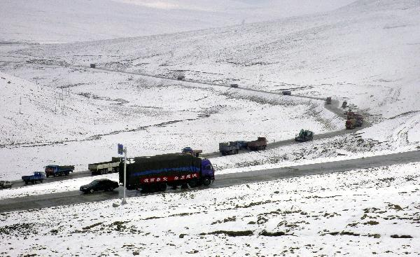 Running on the snow-covered plateau, a long motorcade of cargo vehicles transport quake-relief materials to Yushu, northwest China's Qinghai Province, April 19, 2010. The quake-relief materials were continuously transported to the disaster areas despite the snowfall and frozen road surface.