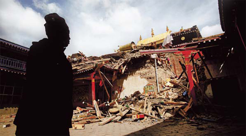 A Tibetan stands in front of the remains of the Gyegu Monastery, the largest Sakya monastery in quake-hit Yushu county.