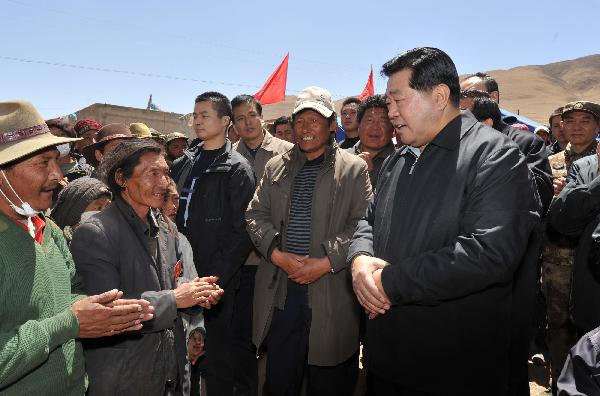Jia Qinglin (R), chairman of the National Committee of the Chinese People's Political Consultative Conference, talks with local residents who have sufferd the earthquakes in quake-hit Yushu County, northwest China's Qinghai Province, on April 26, 2010.