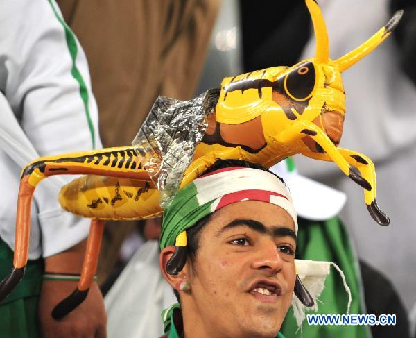 A fan with a grasshopper hat waits for the start of the 2010 World Cup Group C match between England and Algeria in Cape Town, South Africa, June 18, 2010. 