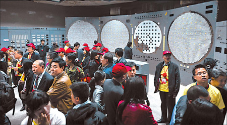 Tourists look around one of the control rooms of the once top-secret nuclear base at Baitao, a remote town hidden in the mountains east of Chongqing. The project was halted in 1982. 