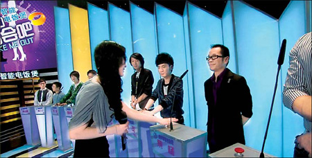 A female contestant switches off the lights of the men she is not interested in for an episode of Hunan TV's popular Take Me Out. Jian Hua / for China Daily 