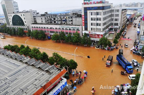 Flooded streets clog traffic in Kunming, capital of Yunnan province, Aug 15, 2010. An overnight downpour on Sunday triggered widespread flooding, which displaced more than 10,000 people and submerged almost 30 hectares of vegetable crops. 