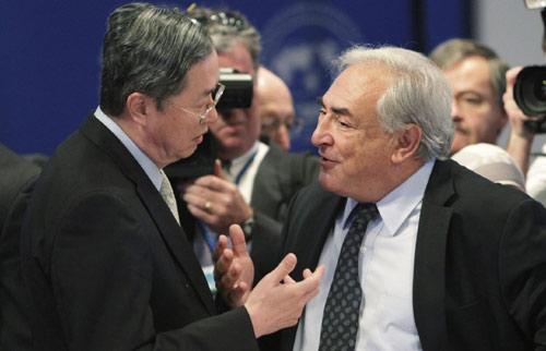 International Monetary Fund (IMF) Managing Director Dominique Strauss-Kahn (R) and Governor of People's Bank of China Zhou Xiaochuan chat at the beginning of the International Monetary and Financial Committee (IMFC) meeting at the IMF headquarters building in Washington Oct 9, 2010.[China Daily via Agencies]