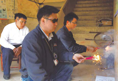 Two employees of the American Fireworks Standards Laboratory test fireworks at a factory in Liuyang, Hunan province, on Dec 11.