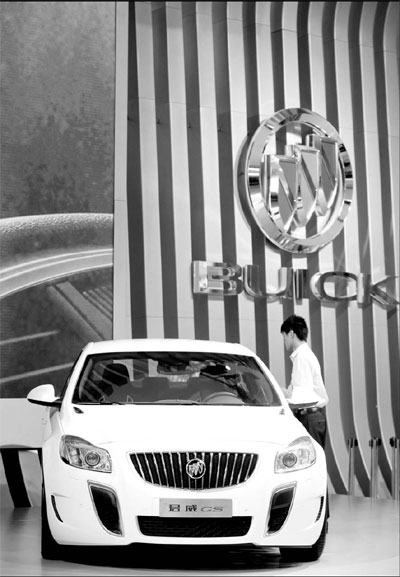 A visitor examines a General Motors Co Buick Regal model at an auto exhibition in Guangzhou. General Motors saw a 50.3 percent jump in sales of its mid-sized Buick models in January, more than double the annual growth rate in 2010. 