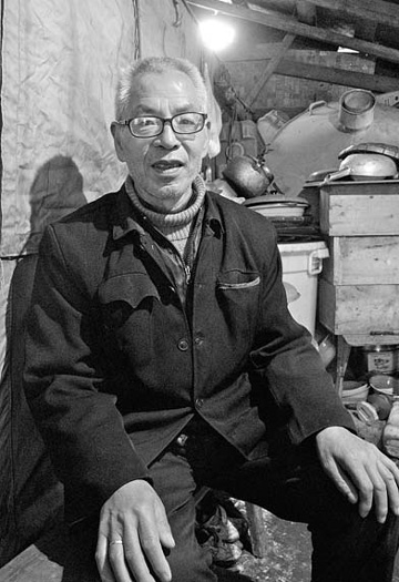 Ma Fuyang, 67, who worked as a cemetery keeper at a mass grave for the May 12 quake victims in Yingxiu town, Sichuan province, sits in his hovel in a mountainside village. 