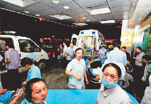 Doctors and nurses receive workers injured in an explosion Friday night at the Foxconn factory in Chengdu where iPad 2s are assembled. Two employees died and 16 were injured.