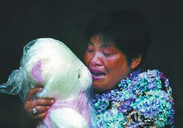 Chen's wife cried with her daughter's doll in her arms. 