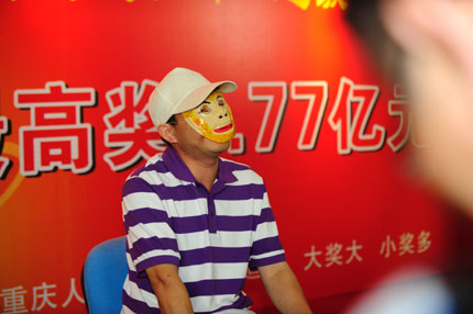 The lottery winner wearing a Monkey King mask takes reporters' questions after claiming a 177 million yuan (US$27.4 million) jackpot in Chongqing. The mystery winner donated 5 million yuan to charity. 
