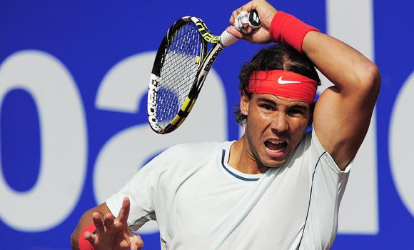 Nadal returns a ball to Paire. 