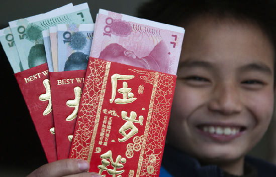 A boy shows the red envelopes he received during Spring Festival this year in Shaoyang, Hunan province. [Photo/China Daily]