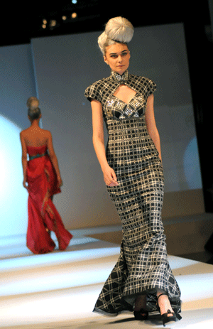 Models display costumes during an environment-friendly fashion show in east China's Shanghai, Jan. 14, 2009. The materials used to make the costumes displayed during the show on Wednesday covered organic cotton, silk, ramie and reused fabric.