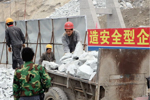 Construction workers shift rocks in a remote area of Sichuan province damaged by the 2008 Wenchuan earthquake. 