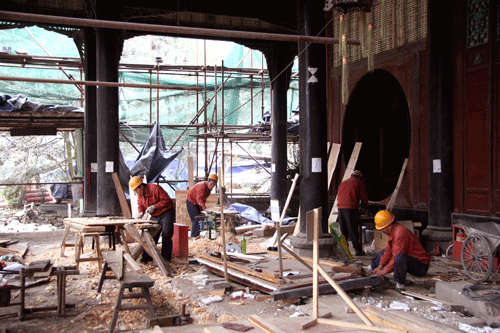 Workers repair inside the temple