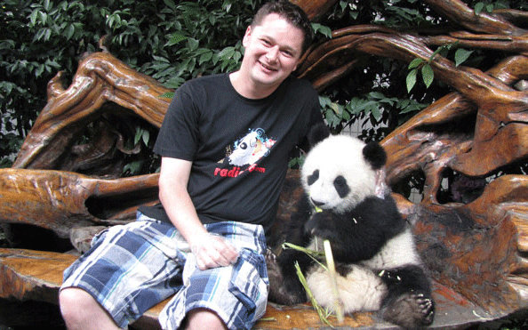 Even the most rugged men, like R86 journalist Asa Butcher, turn to putty when hugged by a baby panda. [Image:Radio86]