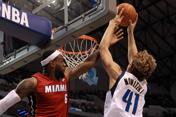  LeBron James and Dirk Nowitzki vie for a rebound during a NBA game on Dec.25, 2011. [Source:Sina.com]