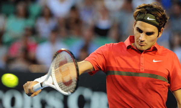 Roger Federer returns a ball during a match against Alexander Kudryavtsev in the first round of Australian Open on Jan. 16, 2012. [Source:Sina.com]