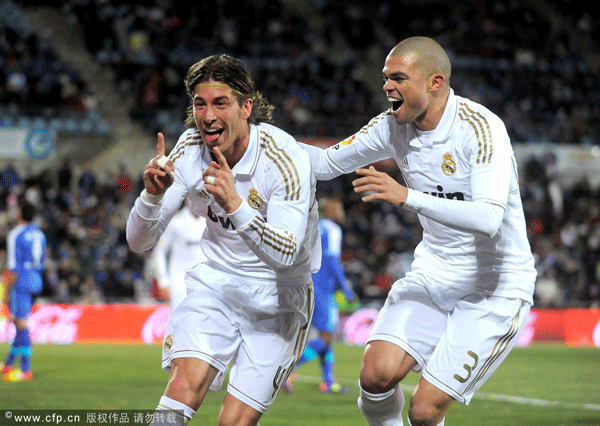  Sergio Ramos (L) and Pepe of Real Madrid celebrate after Ramos scored Real's opening goal against Getafe during the La Liga match between Getafe and Real Madrid at Coliseum Alfonso Perez stadium on February 4, 2012 in Getafe, Spain. 