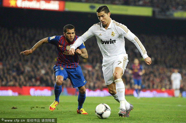 Cristiano Ronaldo of Real Madrid (R) duels for the ball with Dani Alves of FC Barcelona during the Copa del Rey quarter final second leg match between FC Barcelona and Real Madrid at Camp Nou on January 25, 2012 in Barcelona, Spain. 