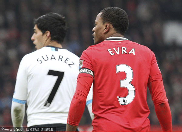 Patrice Evra of Manchester United and Luis Suarez of Liverpool in action during the Barclays Premier League match between Manchester United and Liverpool at Old Trafford on February 11, 2012 in Manchester, England. 