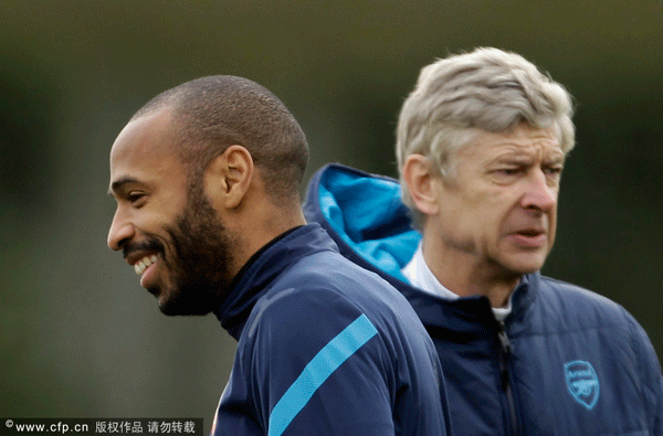 Thierry henry stands near Arsene Wenger during a training session at the Arsenal's facilities in London Colney on Tuesday, Feb. 14, 2012. Arsenal are due to play AC Milan in the first leg of their Champions League last 16 match in Milan on Wednesday.