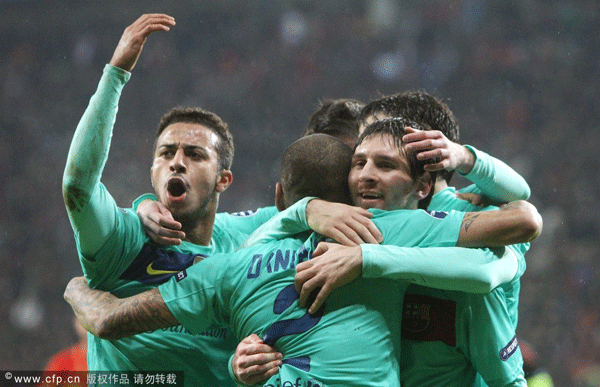 Barcelona's Lionel Messi (R) celebrates his 3-1 goal during the Champions League round of 16 first leg soccer match between Bayer Leverkusen and FC Barcelona at the BayArena in Leverkusen, Germany, on February 14.