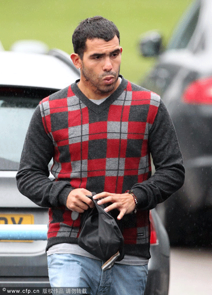 Carlos Tevez leaves the Carrington Training Complex fitness session.