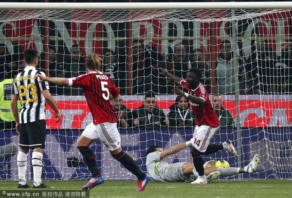 AC Milan forward Sulley Muntari (right) calls for referee's attention as Juventus Goalie Gianluigi Buffon saves a ball beyond the goal line during a Serie A match at the San Siro Stadium in Milan, Italy on Saturday, Feb. 25, 2012.