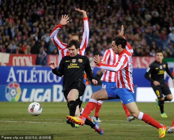Lionel Messi (L) of Barcelona battles for the ball against Juanfran of Atletico Madrid during the La Liga match between Atletico Madrid and Barcelona at Vicente Calderon Stadium on February 26, 2012 in Madrid, Spain