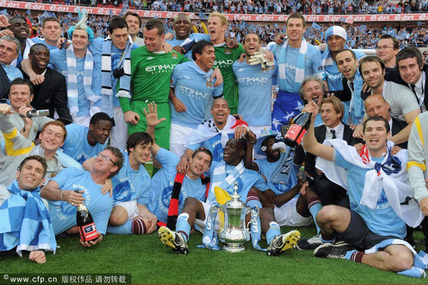 Man City squad celebrate with the trophy after their 1-0 victory during the The FA Cup 2011 Final match between Manchester City and Stoke City at Wembley Stadium on May 14, 2011 in London, England.