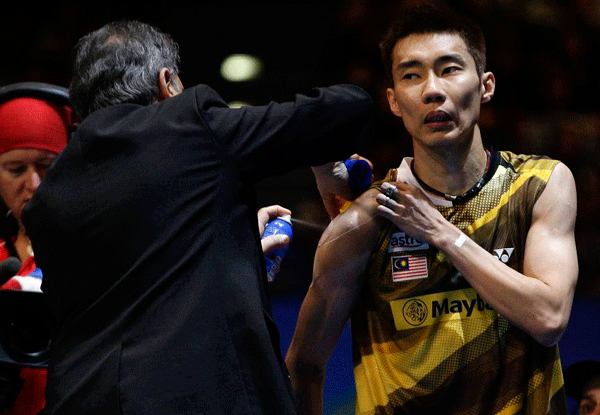 Lee Chon Wei of Malaysia receives treatment during the men's singles final of the All-England Open badminton championships at the National Indoor Arena in Birmingham on March 11, 2012.