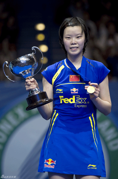  Li Xuerui of China holds the trophy on March 11, 2012 following his victory over teeamate Wang Yihan during the women's singles final of the All-England Open badminton championships at the National Indoor Arena in Birmingham.