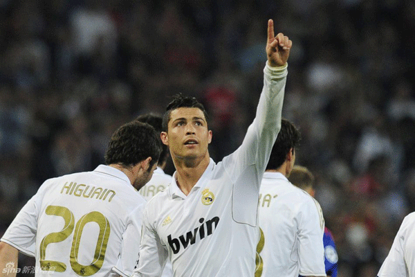 Cristiano Ronaldo and his Real Madrid teammates celebrate after scoring their second goal during the Champions League football match between Real Madrid and CSKA Moscow at the Santiago Bernabeu stadium in Madrid on March 14, 2012