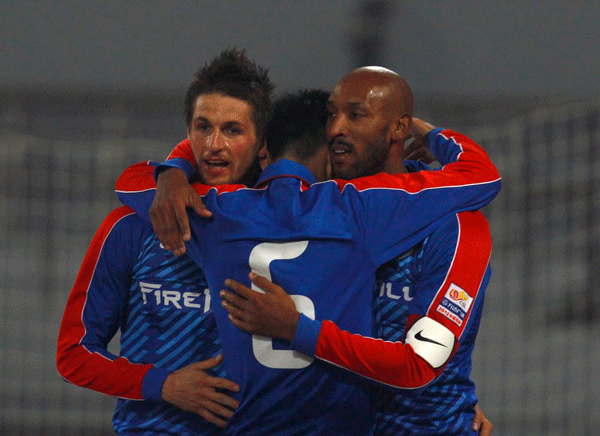 Nicolas Anelka of Shenhua celebrates his first goal with teamates in the Chinese Super League match between Shanghai Shenhua and Beijing Guoan on March 16, 2012.