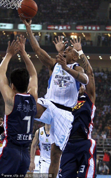 Stephon Marbury of Bejing Ducks goes up for a basket in front of Wang Shipeng of Guangdong Southern Tigers in Game 1 of CBA Finals on March 21, 2012.