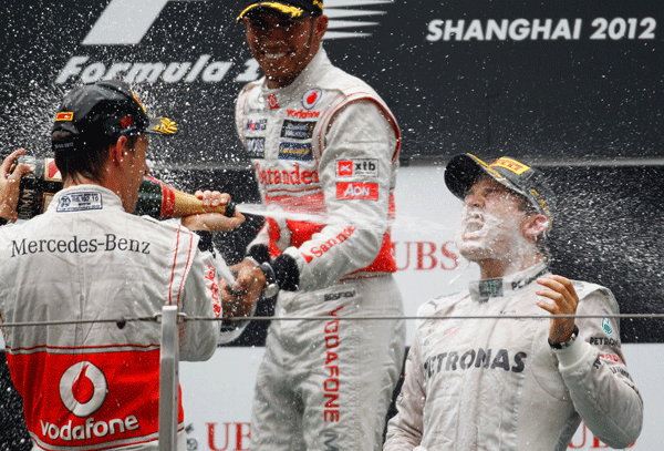  Nico Rosberg celebrates his win in China with Jenson Button and Lewis Hamilton.