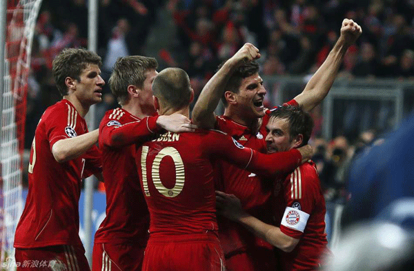 Mario Gomez celebrates with teammates after scoring the winner in the UEFA Champions League semi-final first leg against Real Madrid on April 17, 2012.