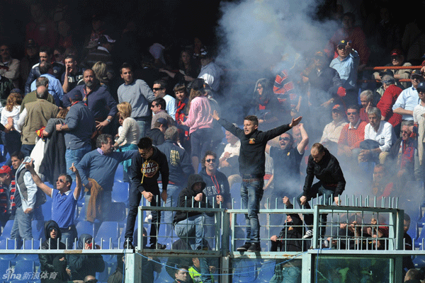 Genoa fans threw flares onto the pitch and climbed atop barriers to protest.