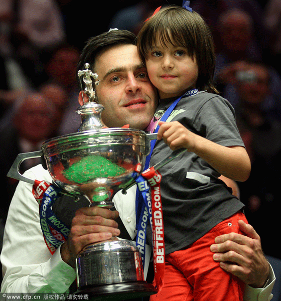 Ronnie O'Sullivan celebrates his victory with his son Ronnie at the Crucible Theatre.