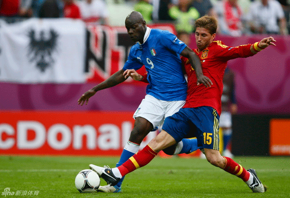 Mario Balotelli of Italy vies for the ball with Spain's Sergio Ramos.