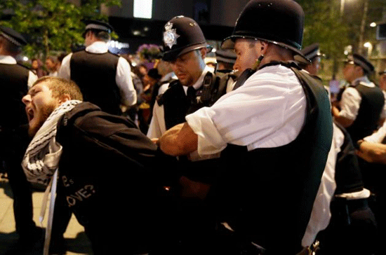 A cyclist is arrested after a protest outside the Olympic Park during the 2012 Summer Olympics Opening Ceremony.