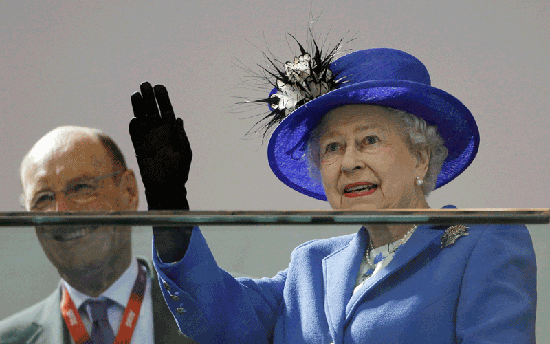 Britain's Queen Elizabeth II waves to spectators inside the Aquatics center during a visit to the Olympic Park.