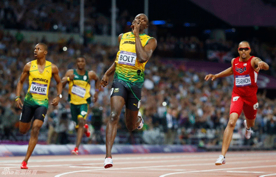  Bolt puts his finger to his lips after crossing the finishing line.
