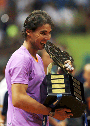 Rafael Nadal bites the trophy after winning the Brazil Open final on Feb.17, 2013.