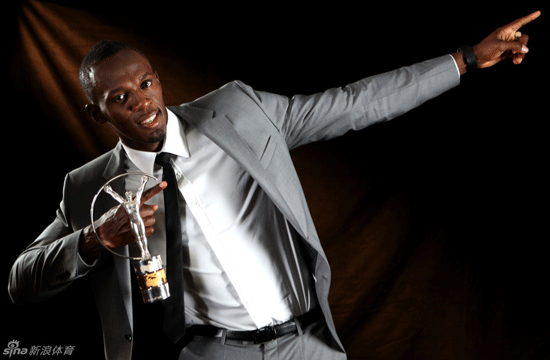 Usain Bolt poses with Laureus World Sports Awards trophy.
